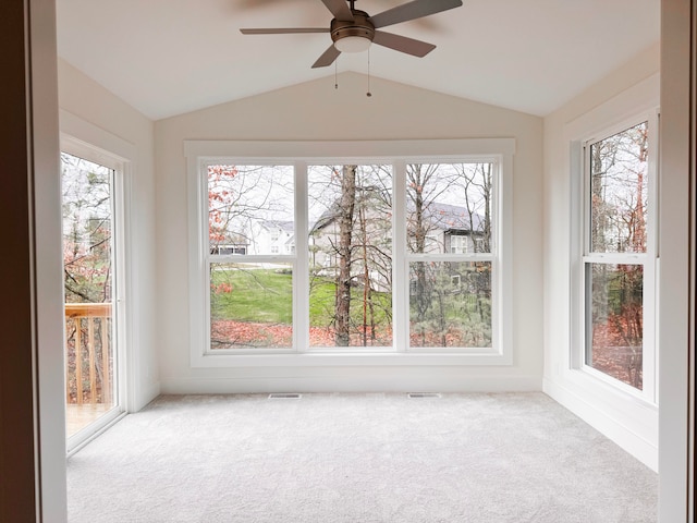 unfurnished sunroom with ceiling fan, visible vents, and vaulted ceiling