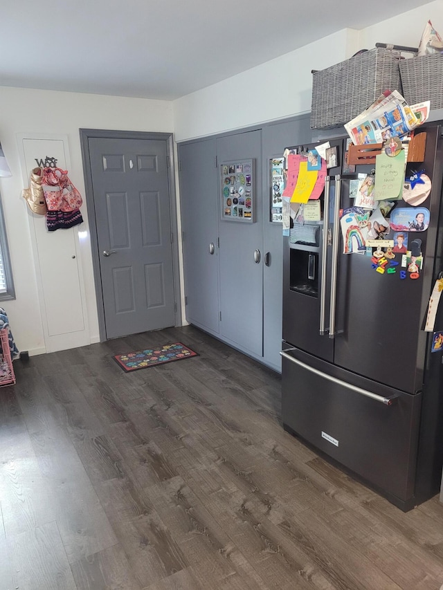 kitchen featuring dark hardwood / wood-style flooring and fridge with ice dispenser