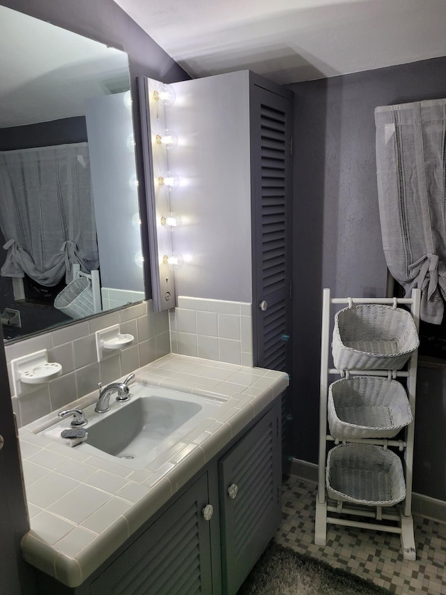 bathroom featuring tile patterned floors, decorative backsplash, and vanity