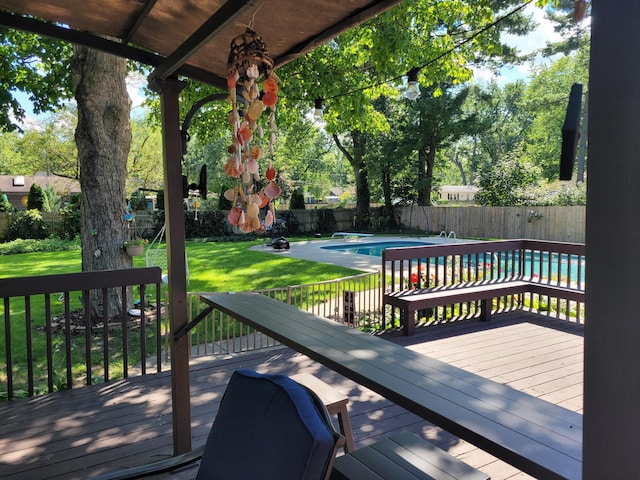 wooden terrace featuring a fenced in pool and a yard