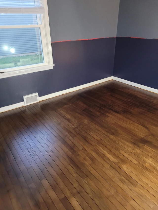 spare room with wood-type flooring