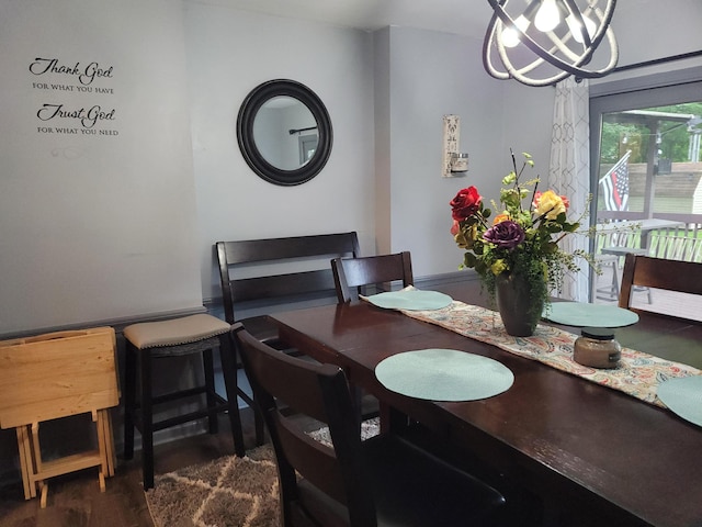 dining area featuring a notable chandelier and dark hardwood / wood-style floors