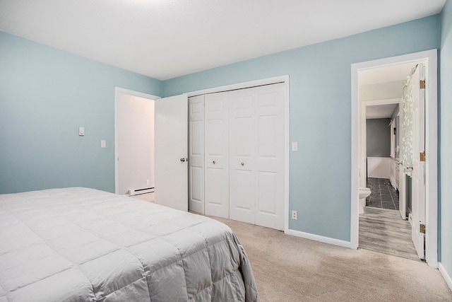 carpeted bedroom featuring a closet and a baseboard radiator