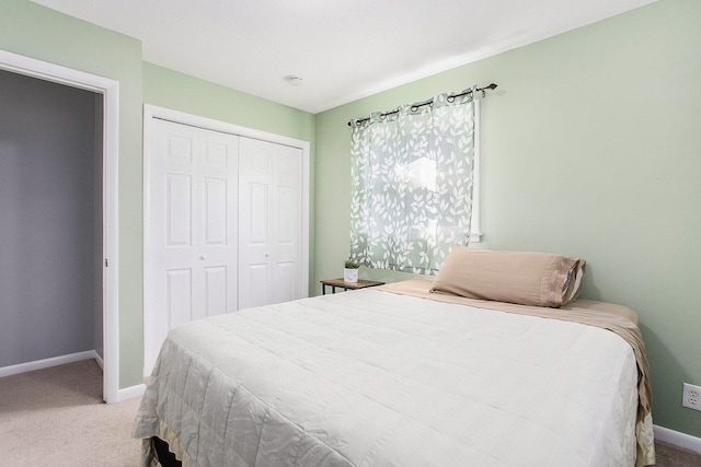 bedroom with light colored carpet and a closet