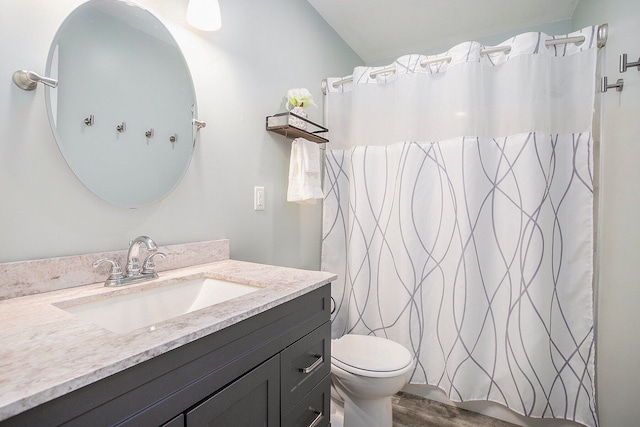 bathroom featuring vanity, toilet, a shower with shower curtain, and hardwood / wood-style floors