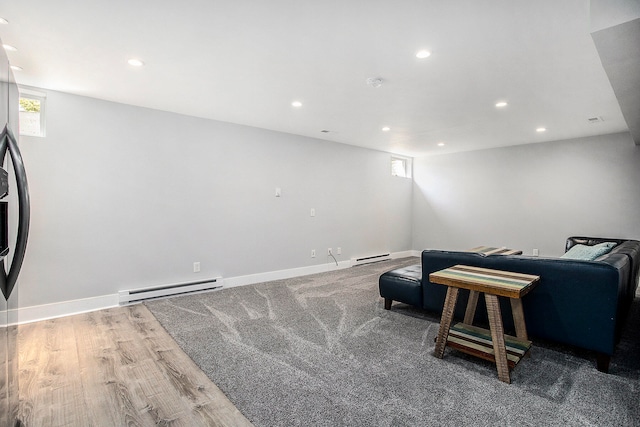 living area with hardwood / wood-style floors and a baseboard radiator