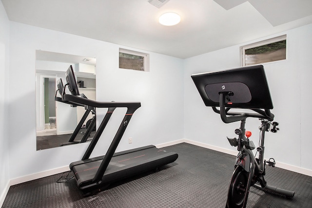 workout room with dark colored carpet