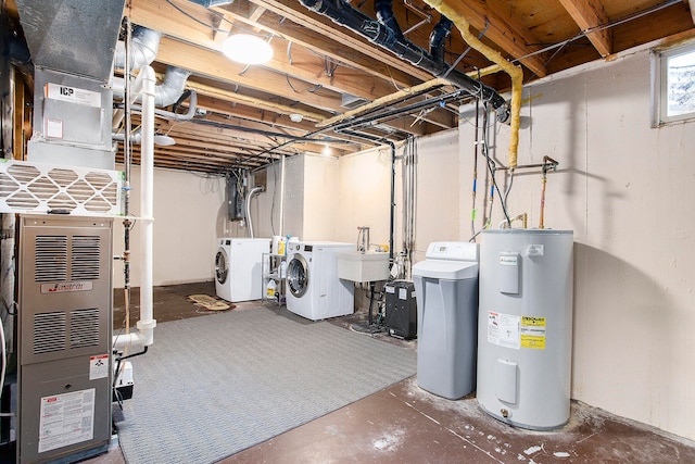 basement featuring washer and clothes dryer, sink, and water heater