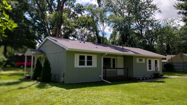 rear view of property featuring a yard