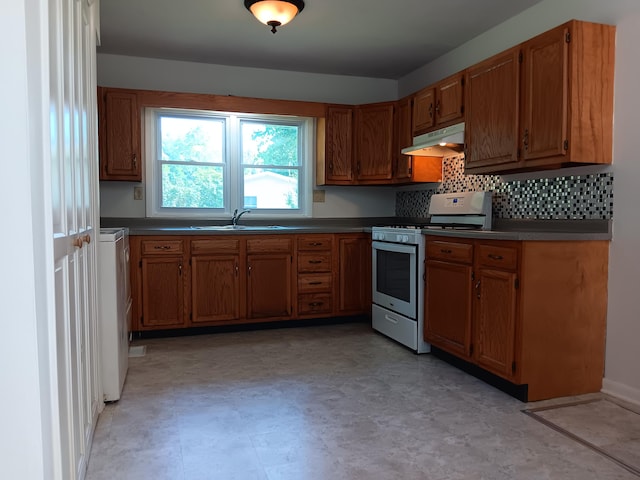 kitchen with tasteful backsplash, light tile patterned flooring, gas range gas stove, and sink