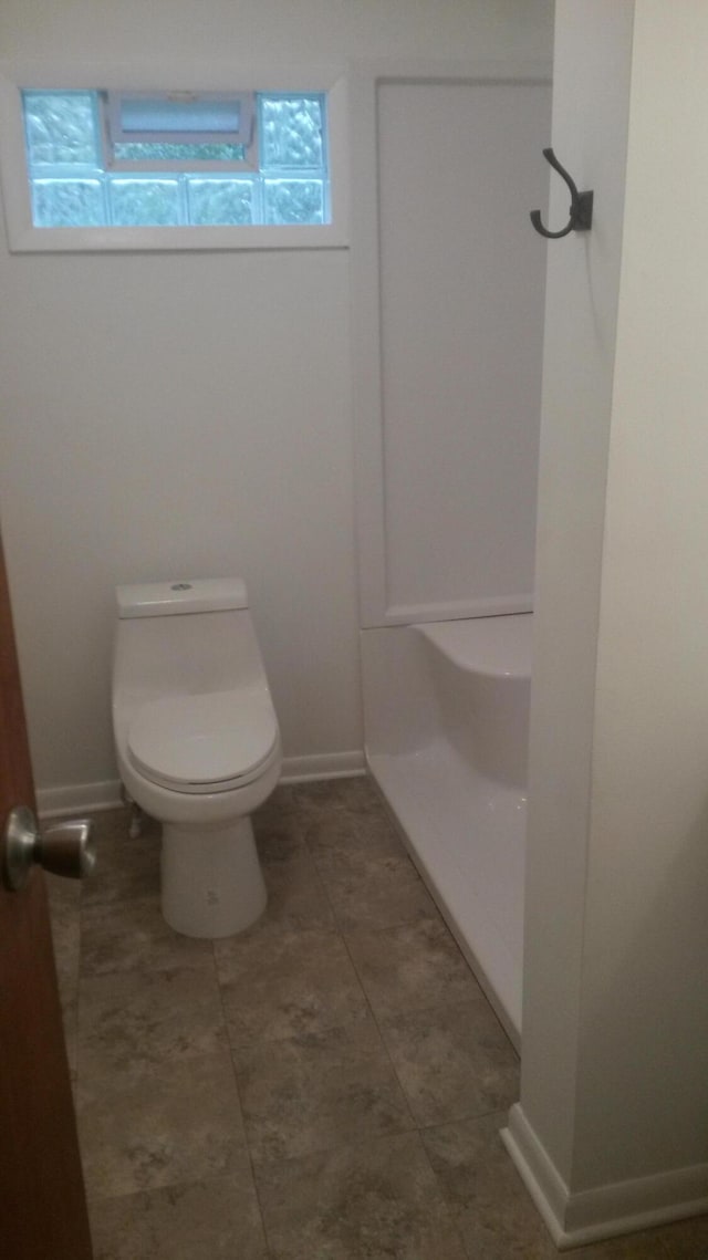 bathroom featuring toilet and tile patterned floors