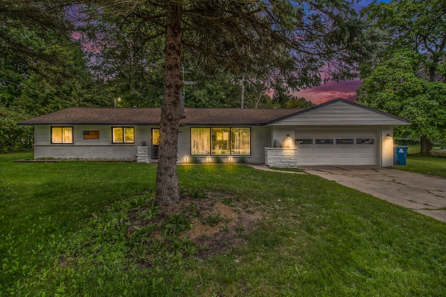 single story home with a garage and a yard