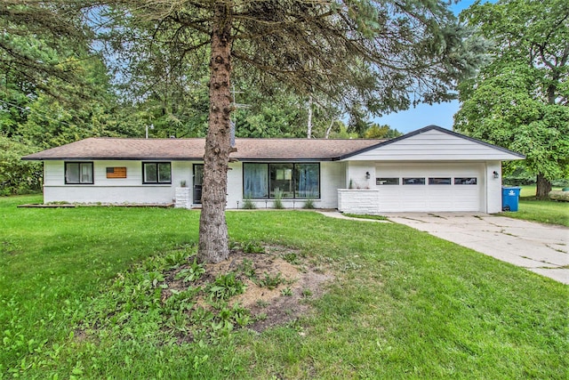 ranch-style home with an attached garage, concrete driveway, and a front yard