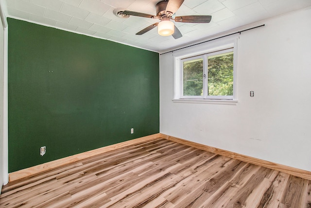 unfurnished room featuring ceiling fan, ornamental molding, and hardwood / wood-style floors