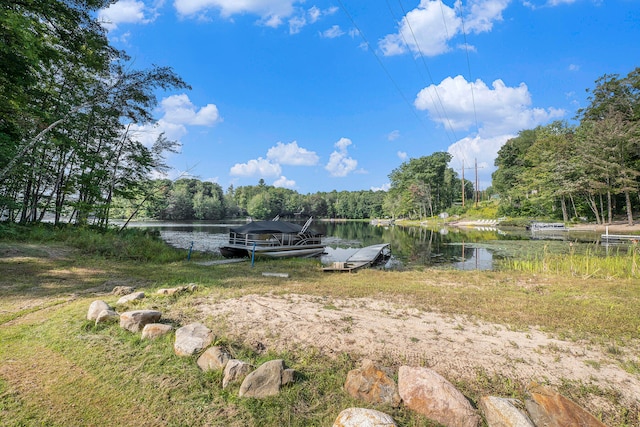 view of yard with a boat dock and a water view