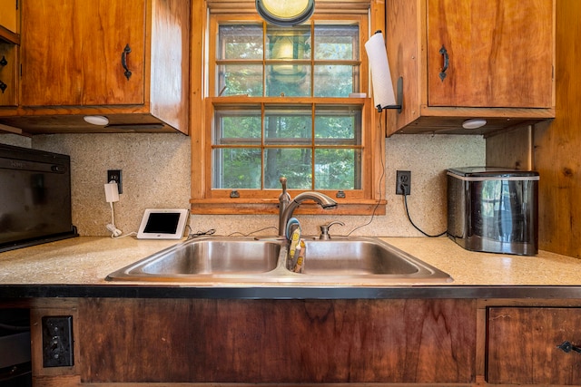 kitchen featuring tasteful backsplash and sink