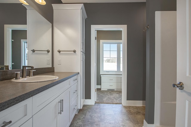 bathroom featuring tile patterned flooring and vanity