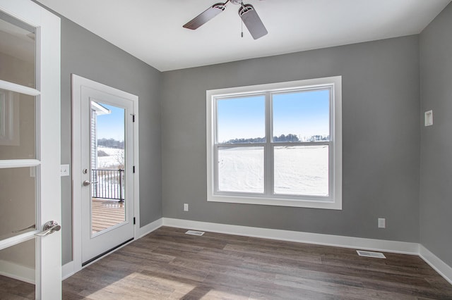 spare room featuring wood-type flooring, ceiling fan, and a water view