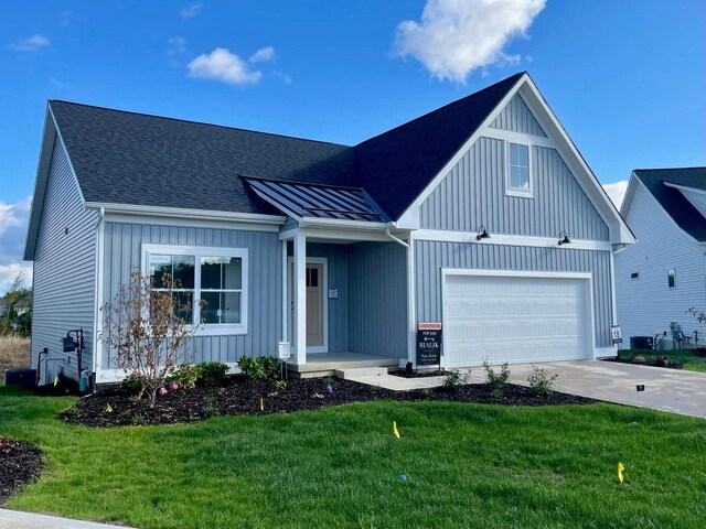 view of front of home featuring a front lawn and central AC