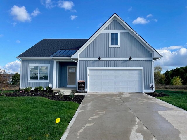 view of front of home with a garage and a front yard