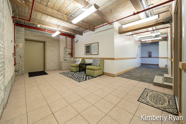 interior space with wood ceiling, light tile patterned floors, and brick wall