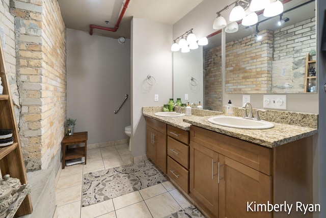 bathroom with vanity, tile patterned flooring, and toilet