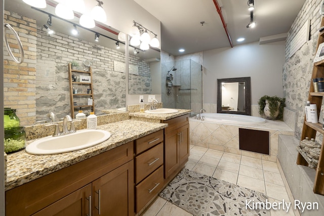 bathroom featuring independent shower and bath, vanity, and tile patterned flooring