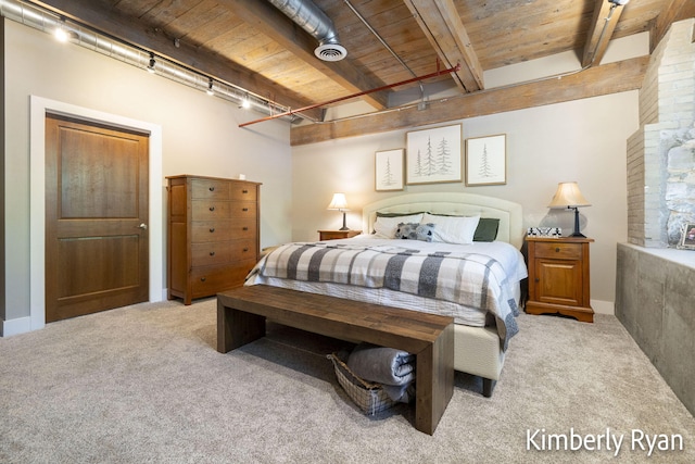 bedroom with wooden ceiling, rail lighting, beam ceiling, and light colored carpet