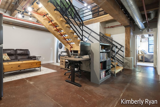 basement featuring stacked washer and dryer