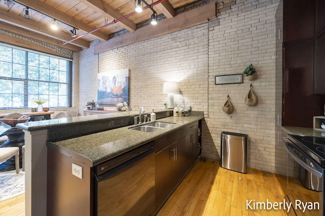 kitchen featuring beam ceiling, sink, brick wall, light hardwood / wood-style flooring, and dishwasher