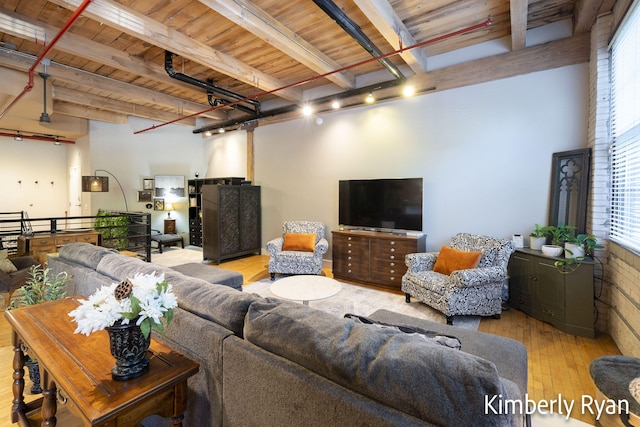 living room with wooden ceiling, beam ceiling, and light hardwood / wood-style flooring