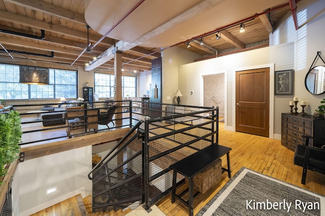 dining area with light hardwood / wood-style flooring, a wealth of natural light, and beam ceiling