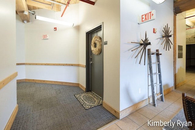 hall with light tile patterned floors