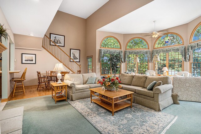 living room with wood-type flooring and ceiling fan