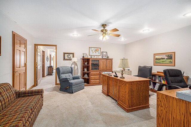 carpeted office space with ceiling fan