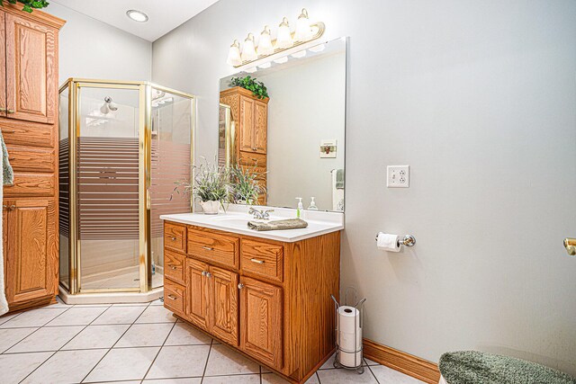 bathroom with tile patterned flooring, vanity, and a shower with door