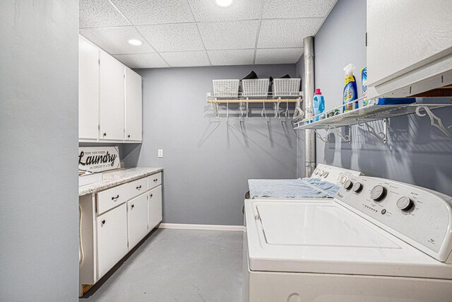 washroom with washing machine and dryer and cabinets