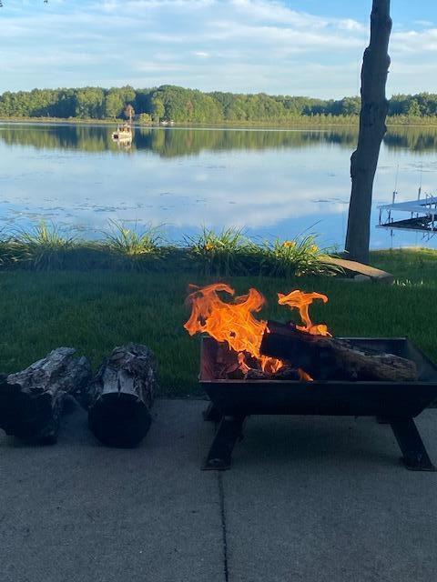 property view of water featuring a fire pit