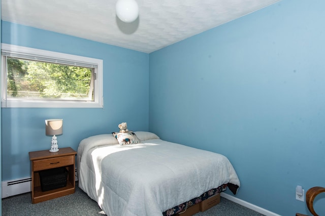 carpeted bedroom featuring a baseboard heating unit