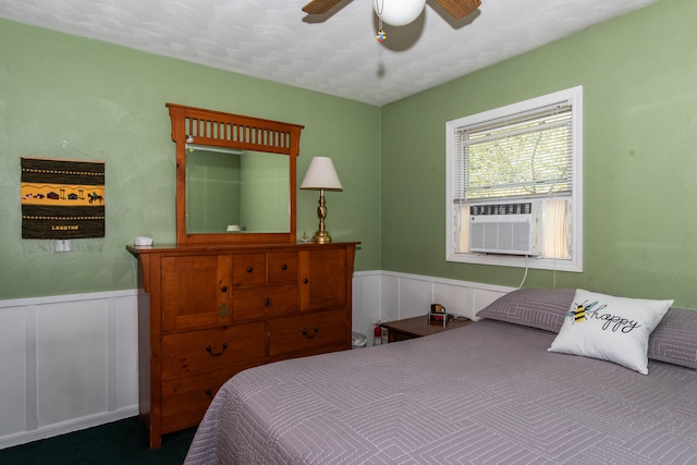 bedroom with ceiling fan and a textured ceiling