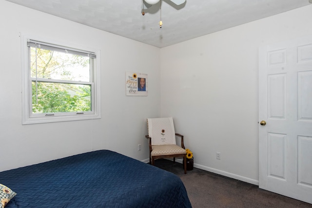 bedroom with ceiling fan and dark carpet