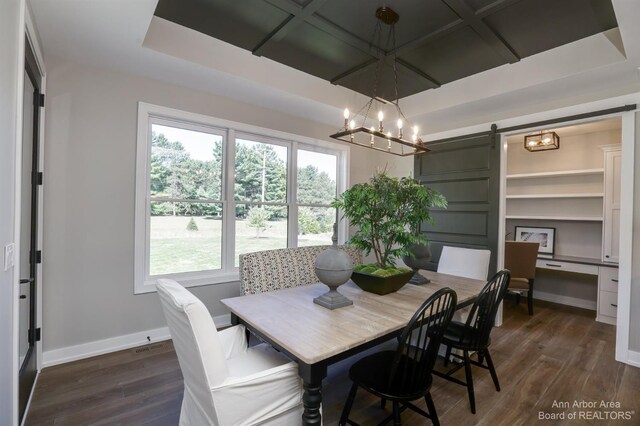 dining room with a wealth of natural light, a chandelier, a barn door, and dark hardwood / wood-style floors