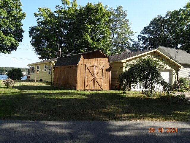 view of outbuilding with a yard