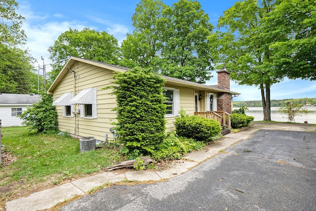 5540 Cozy Point Dr, Newaygo, MI 49337 - view of front of property featuring a chimney and a water view