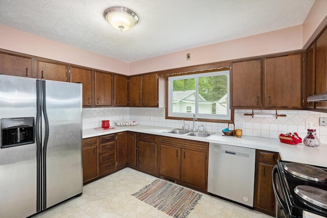 5540 Cozy Point Dr, Newaygo, MI 49337 - kitchen featuring appliances with stainless steel finishes, light countertops, a sink, light flooring, and under cabinet range hood