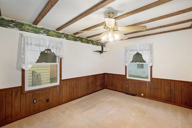 5540 Cozy Point Dr, Newaygo, MI 49337 - empty room with beamed ceiling, wood walls, a wainscoted wall, and a ceiling fan