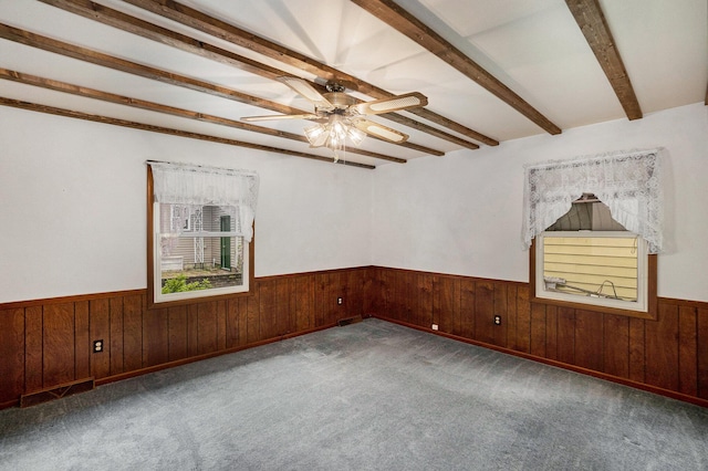 5540 Cozy Point Dr, Newaygo, MI 49337 - spare room featuring wainscoting, wooden walls, ceiling fan, beam ceiling, and carpet flooring