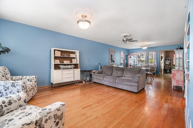 living room with ceiling fan and hardwood / wood-style flooring