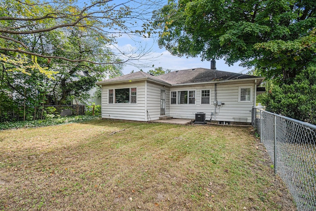 rear view of property with a yard