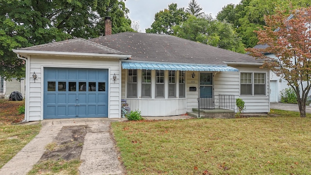 view of front of house with a front yard and a garage